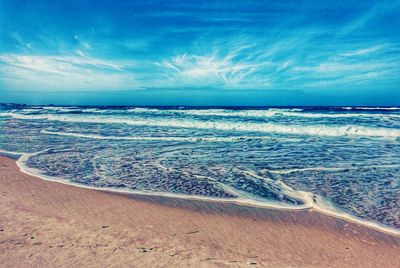 Scenic view of sea against cloudy sky