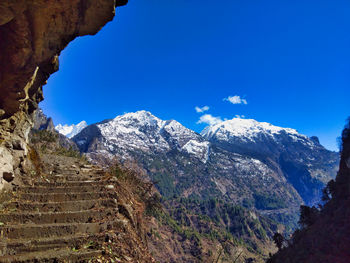 Scenic view of mountains against blue sky