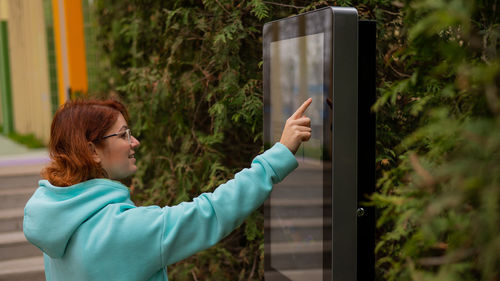 Side view of woman looking at map