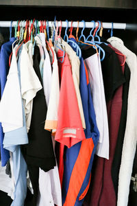 Various clothes hanging on rack