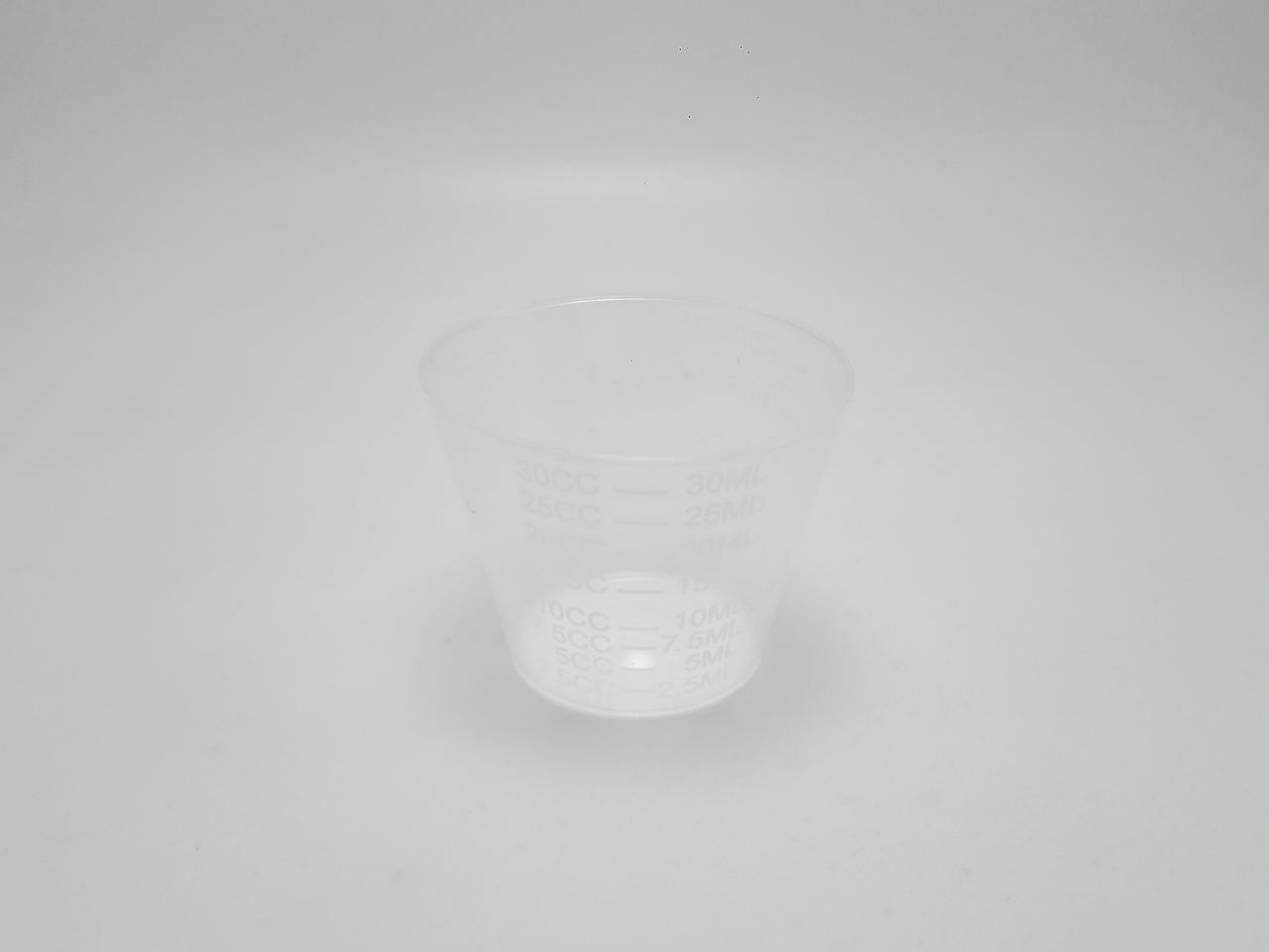 CLOSE-UP OF EMPTY GLASS OVER WHITE BACKGROUND
