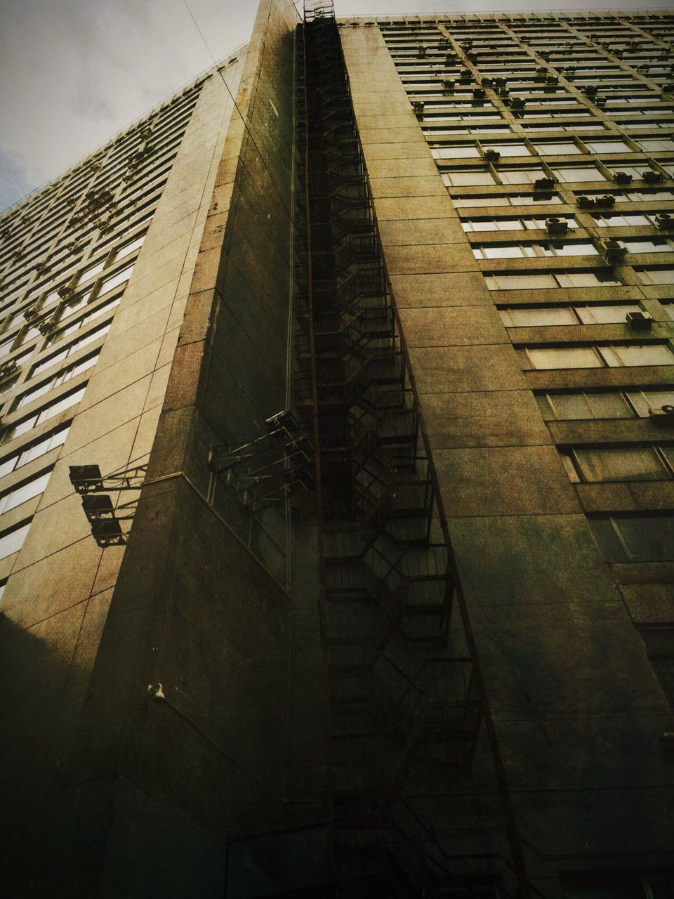 architecture, built structure, building exterior, low angle view, building, sky, city, modern, no people, office building, outdoors, shadow, day, sunlight, residential building, residential structure, wall - building feature, window, brick wall, diminishing perspective