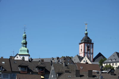 Low angle view of buildings against blue sky