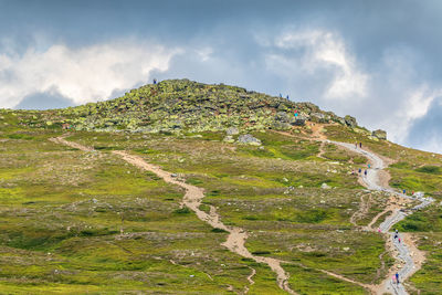 People who walk up to the top of the mountain