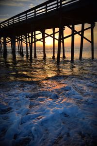 Pier on sea during sunset