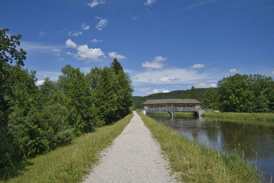 Arch bridge over canal against sky