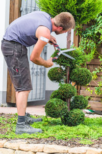 Close-up of man standing by plants
