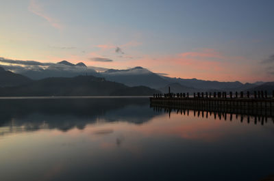 Scenic view of lake against sky during sunset