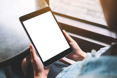 Close-up of woman using digital tablet