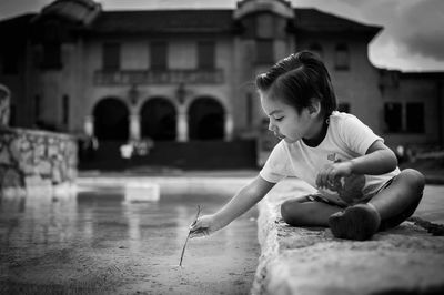 Boy playing against building