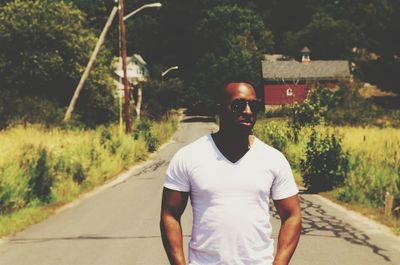 Young man wearing sunglasses on road