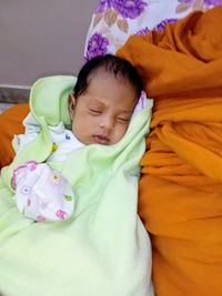 Cute baby girl sleeping on bed
