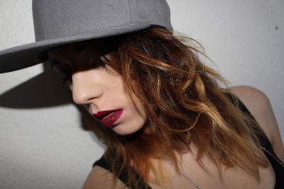 Close-up of young woman wearing hat
