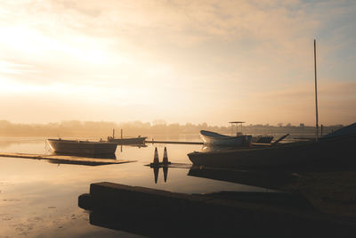 Boats in marina at sunset