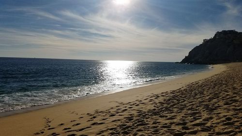 Scenic view of beach against sky during sunset