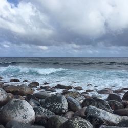 Scenic view of sea against cloudy sky