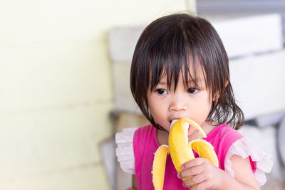 Baby girl eating banana