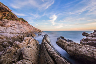 Scenic view of sea and rocks against sky