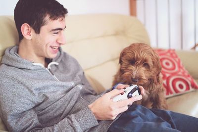 Young woman with dog on mobile phone