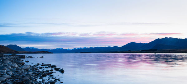 Scenic view of lake against sky during sunset