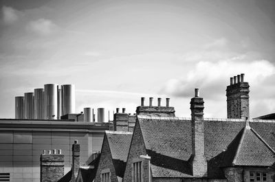 Industrial building against cloudy sky