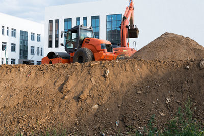 Construction site by building against sky