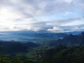 Scenic view of mountains against cloudy sky