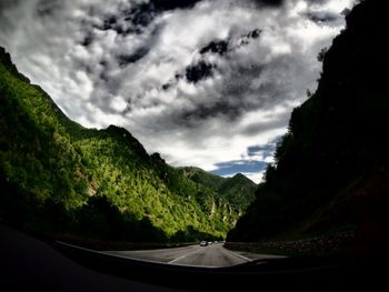 Scenic view of mountains against cloudy sky