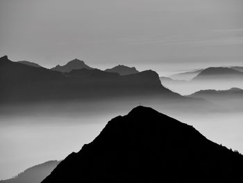 Silhouette mountain range against sky