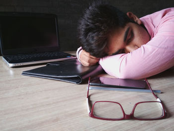 Boy with objects sleeping at table