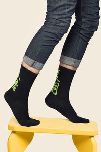 Low section of person wearing shoes standing against white background