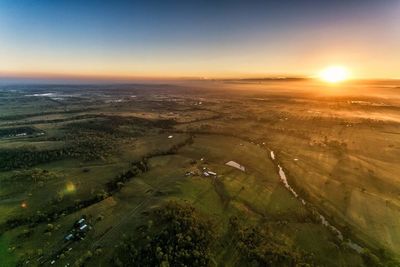 Aerial view of lake against sky during sunset