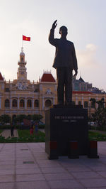 Full length of man standing at town square against sky