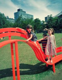 People sitting on swing in park