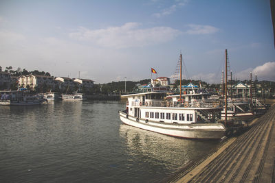 Boats in sea against sky in city