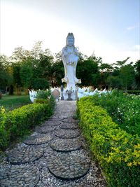 Statue amidst trees against sky