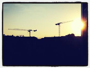 Low angle view of silhouette building against sky