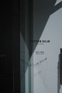 Low angle view of text on glass window