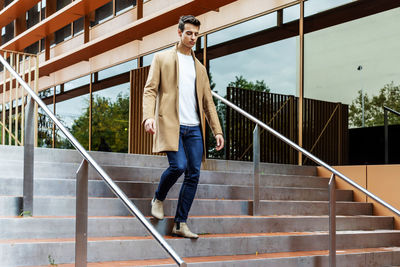 Full length of young man climbing staircase