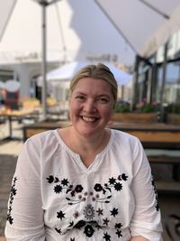 Portrait of smiling woman sitting outdoors