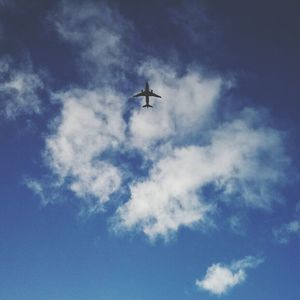 Low angle view of airplane flying in sky