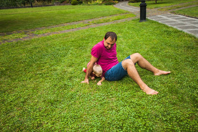 High angle view of man relaxing on grass