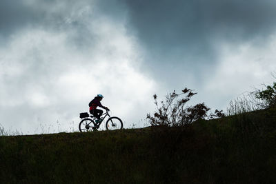 Low angle view of bicycle on field against sky