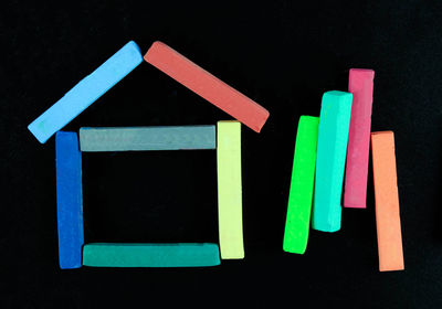 Close-up of multi colored crayons over black background