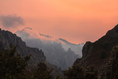 Scenic view of mountains against dramatic sky