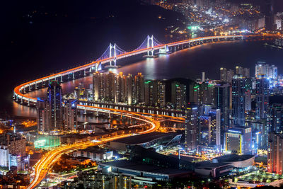 High angle view of illuminated bridge and buildings at night