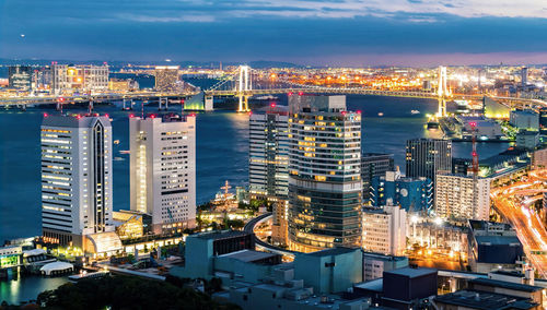 High angle view of illuminated buildings against sky at night