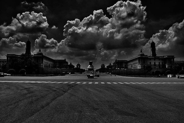 building exterior, architecture, sky, built structure, cloud - sky, cloudy, street, weather, road, cloud, transportation, car, house, religion, incidental people, church, land vehicle, overcast, outdoors, storm cloud