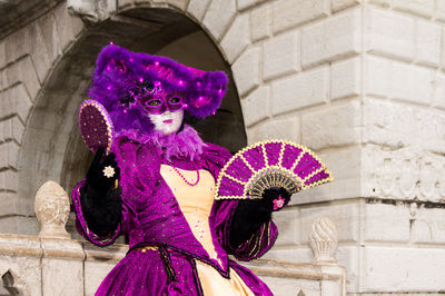 Venetian carnival - woman with purple umbrella