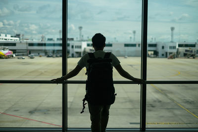 Rear view of man standing at airport